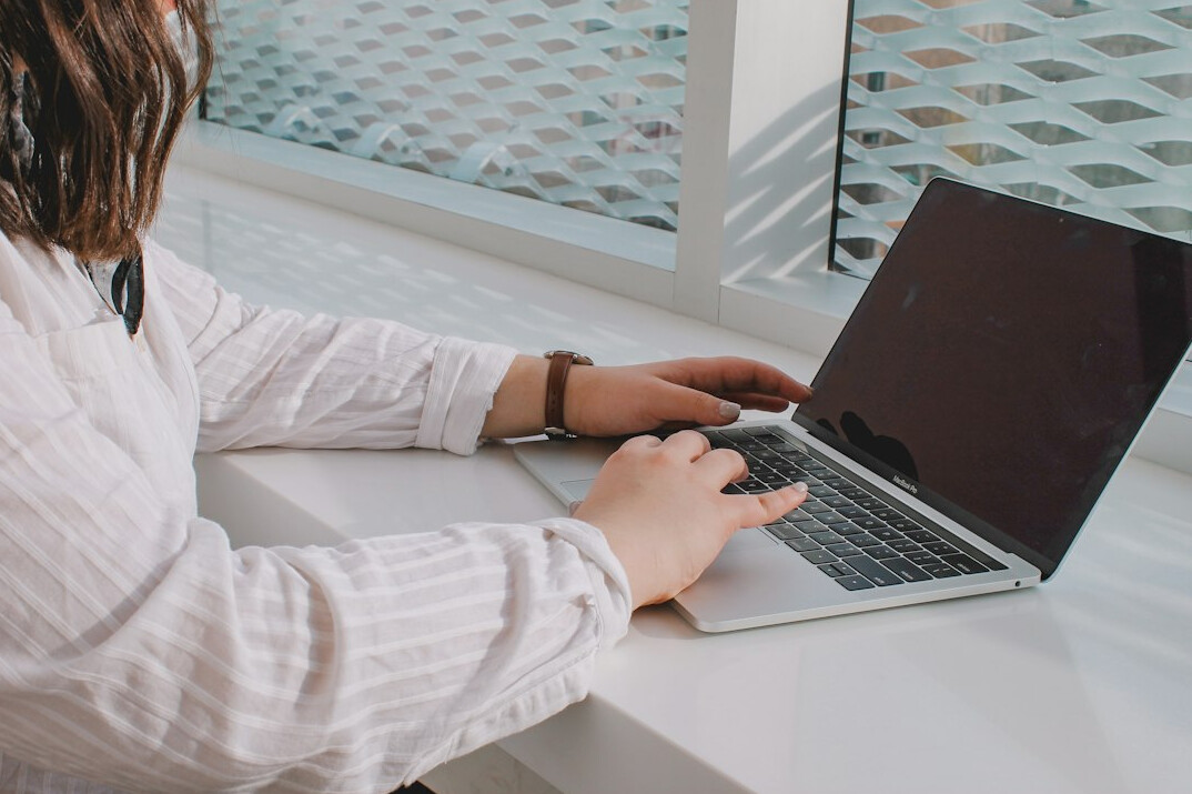 person writing blog post on laptop